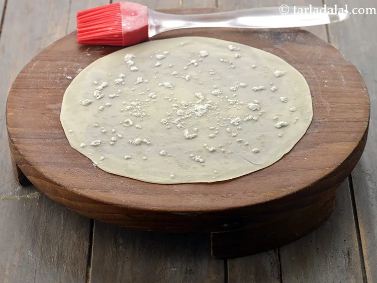 Step 9 – Roll 1 more portion of the dough into a 175 mm. (7&rdquo;) diameter circle using …