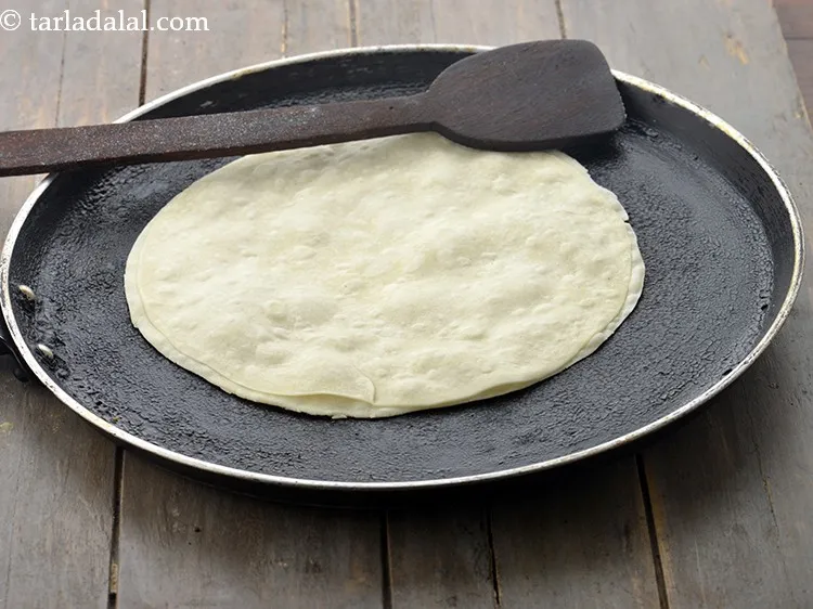 Step 12 – Heat a non-stick tava (griddle) and cook it on a medium flame for 30 seconds …