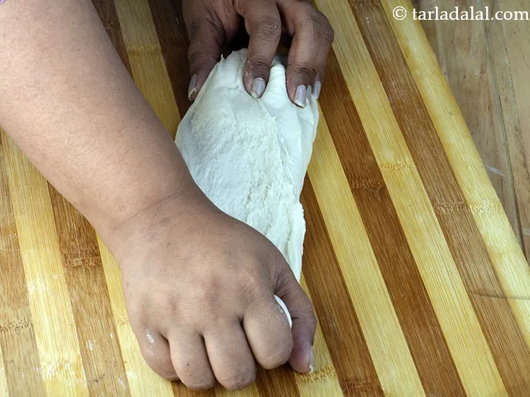 स्टेप 13 – मैदा को किसी समतल, सूखी जगह पर डस्ट कर, २ …