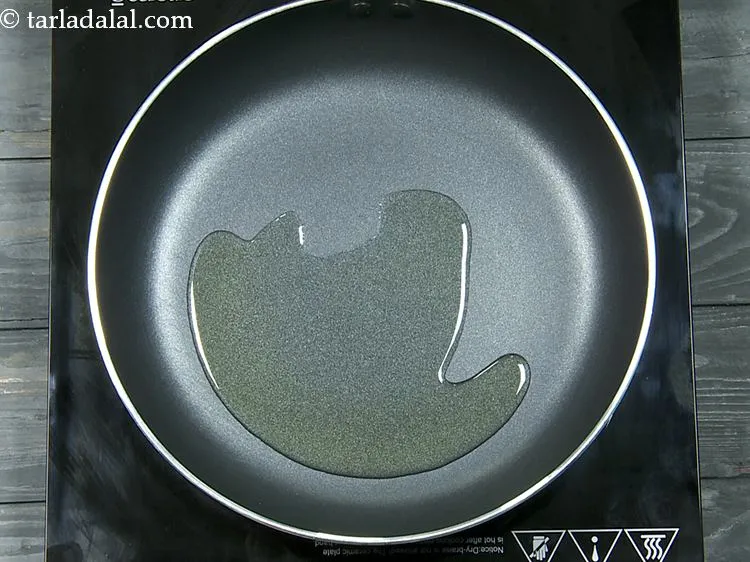 Step 5 – For preparing <a href="https://www.tarladalal.com/recipes-for-Chinese-Veg-Chinese-Recipes-77" target="_blank">Indo-Chinese</a> <strong>Hot Garlic Sauce</strong>, heat the oil in a broad non-stick …