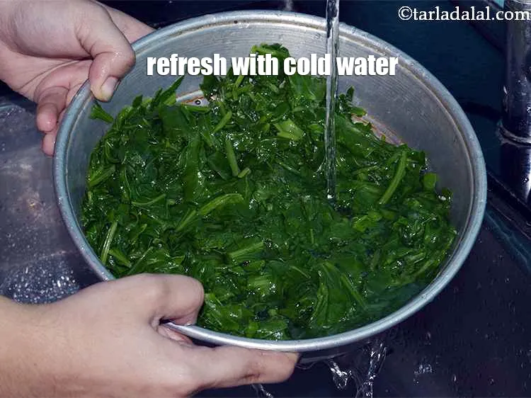 Step 11 – Run the strainer below cold water to refresh the spinach. This stops the cooking process …