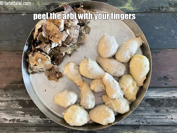 Step 12 – Peel the arbi with your fingers.