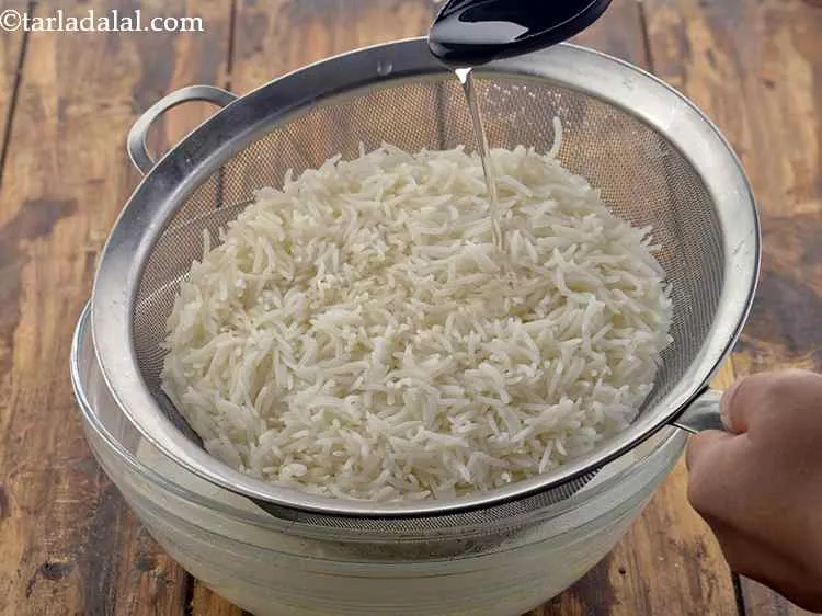 Step 18 – Add the remaining 1 tbsp of oil. This helps in preventing the&nbsp;<strong>basmati rice</strong>&nbsp;from sticking together.