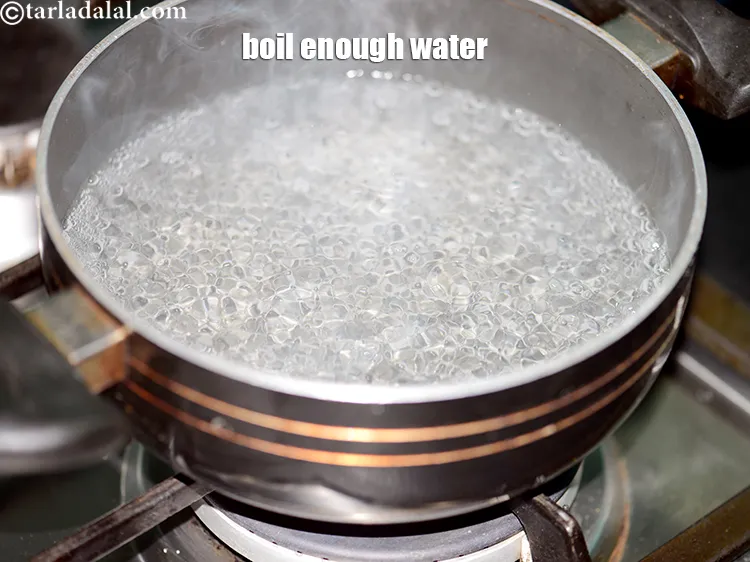 Step 14 – To cook chana dal, heat 1 cup of water in a deep non-stick pan.