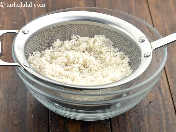 Step 6 – Drain the rice using a strainer. Disacrd the water and and keep the rice aside.