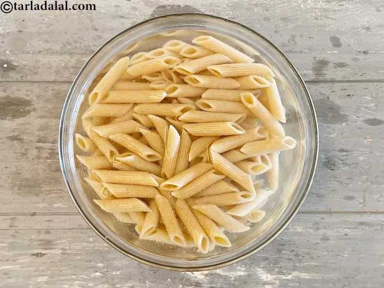 Step 12 – Transfer cooked&nbsp;<strong>whole wheat pasta&nbsp;</strong>to a bowl of cold water to refresh it.&nbsp;