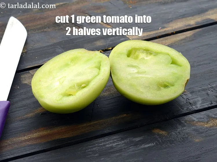 Step 6 – Cut 1 green tomato into 2 halves vertically using a sharp knife.&nbsp;