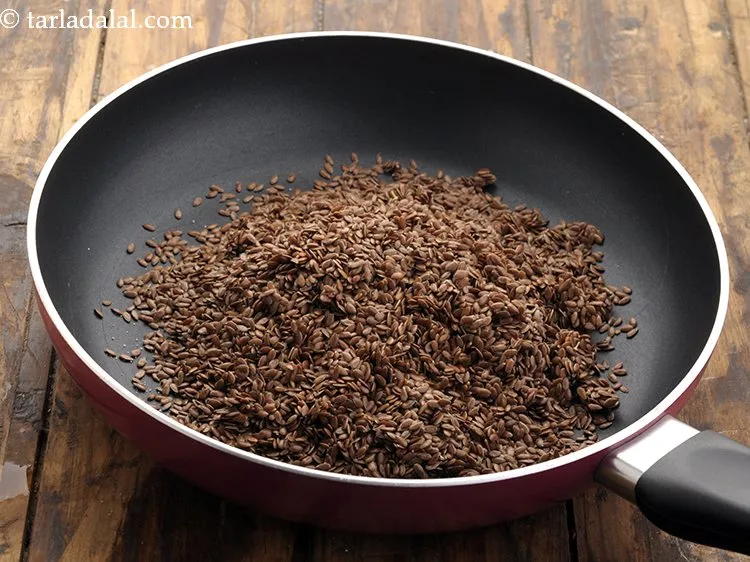 Step 14 – Transfer the mixture of <strong>healthy mukhwas</strong> into a broad non-stick pan. Notice that the flax …