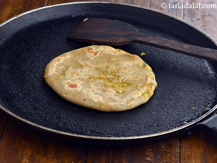 Step 22 – Heat a non-stick tava (griddle) and cook the aloo paratha for for 15 seconds on …