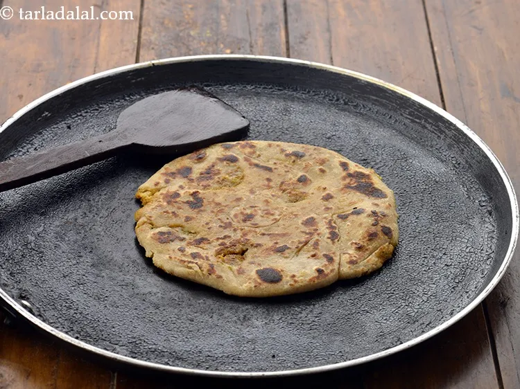 Step 26 – Heat a non-stick tava (griddle), cook it on a medium flame using 1 tsp of …