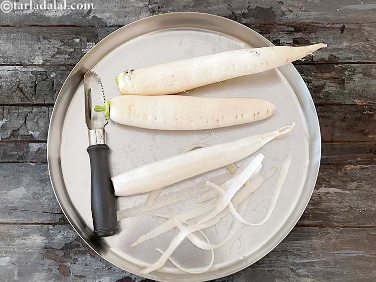 Step 6 – Grate the mooli using a peeler to remove the outer skin.