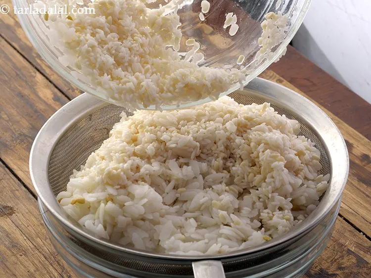 Step 17 – Now, drain the soaked par-boiled rice, raw rice, and thick beaten rice using a strainer.
