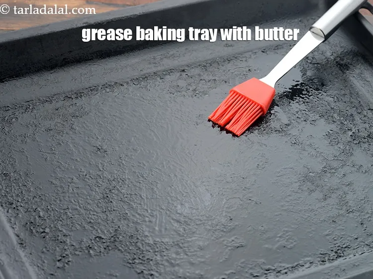 Step 20 – Grease a baking tray with 1/4 tsp&nbsp;<a href="https://www.tarladalal.com/glossary-butter-makhan-233i">butter</a>.