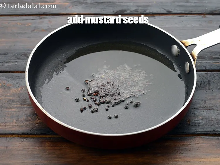 Step 49 – Add 1/2 tsp&nbsp;<a href="https://www.tarladalal.com/glossary-mustard-seeds-sarson-rai-sarson-ke-beej-525i">mustard seeds ( rai / sarson)</a>.&nbsp;