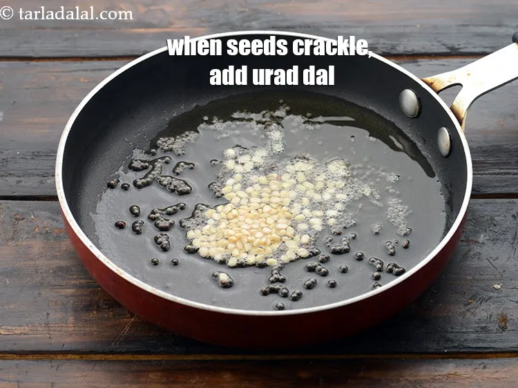 Step 50 – When the seeds crackle, add 1/2 tsp&nbsp;<a href="https://www.tarladalal.com/glossary-urad-dal-split-black-lentil-941i">urad dal (split black lentils)</a>.&nbsp;
