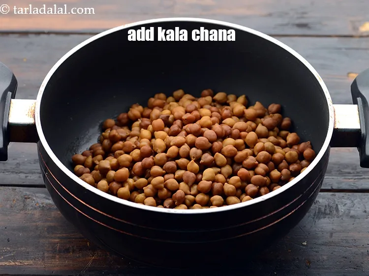Step 26 – Add&nbsp;2 cups&nbsp;soaked and&nbsp;<a href="https://www.tarladalal.com/glossary-boiled-kala-chana-1433i">boiled kala chana (brown chick peas)</a>.&nbsp;