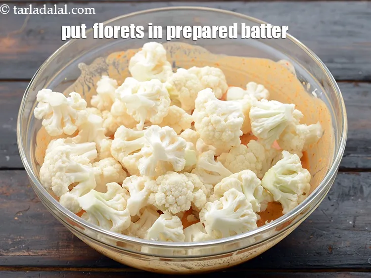 Step 21 – Put the cauliflower florets in the prepared batter.&nbsp;