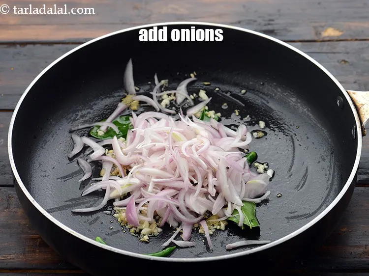 Step 32 – Add 1/2 cup&nbsp;<a href="https://www.tarladalal.com/glossary-sliced-onions-745i">sliced onions</a>.