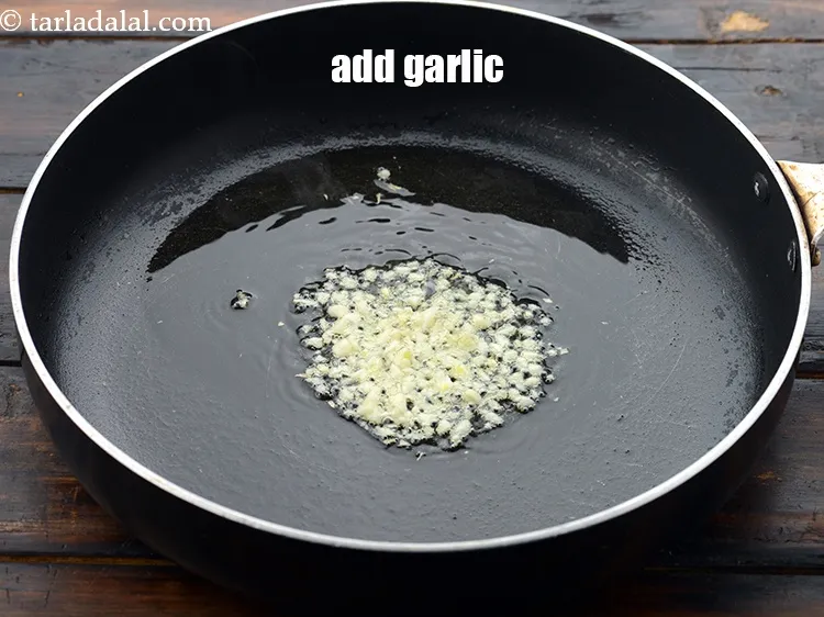 Step 27 – Add 1 tsp&nbsp;finely&nbsp;<a href="https://www.tarladalal.com/glossary-chopped-garlic-790i">chopped garlic (lehsun)</a>.