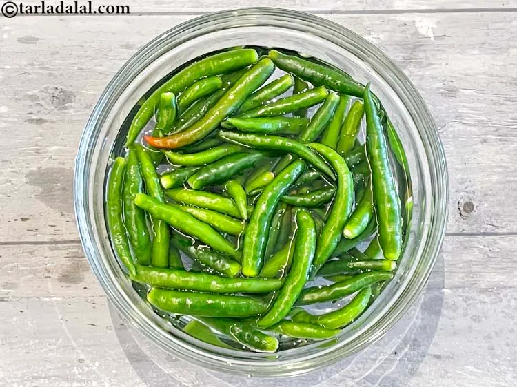 Step 3 – Put the green chillies in a deep glass bowl of water.