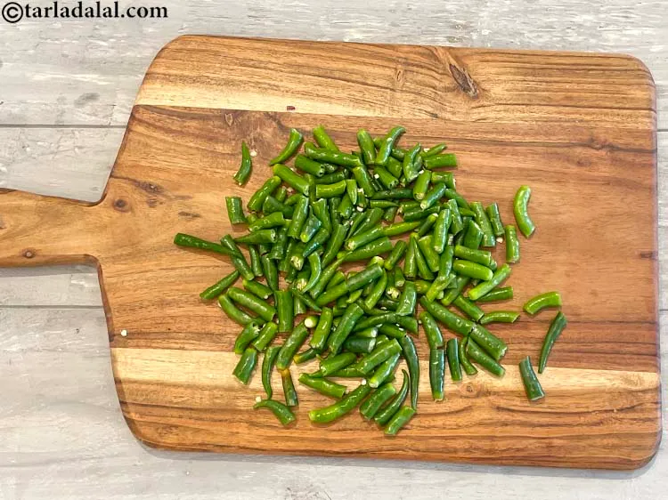 Step 6 – Cut each green chilli&nbsp;into 3 pieces as we are going to blend it.