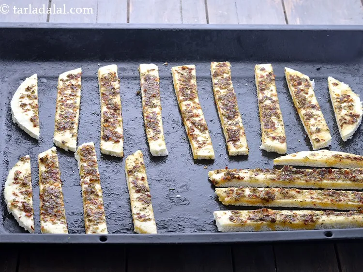 Step 15 – Cut them horizontally into medium sized strips and place them on a greased baking tray.