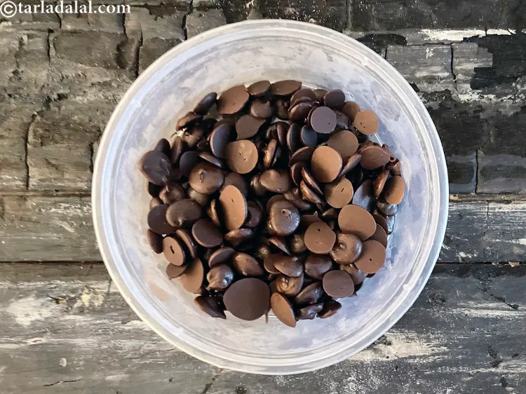 Step 25 – Transfer the mixture back into the same aluminium shallow container, add 1/2 cup&nbsp;<a href="https://www.tarladalal.com/glossary-chocolate-chips-325i">chocolate chips</a> …