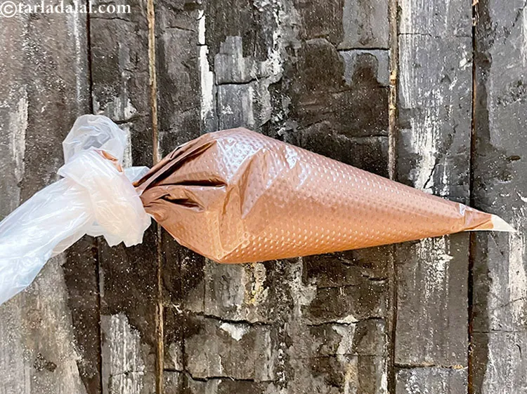 Step 14 – Pour it in a piping bag and make a small hole at the tip using …