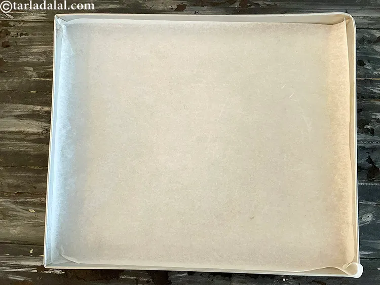 Step 16 – Cover the tray with parchment paper as we will be piping dark chocolate on it.