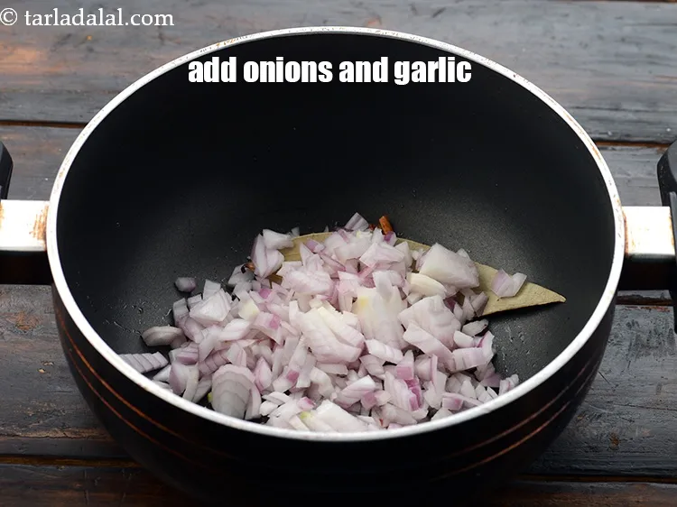 Step 18 – Add 1/2 cup&nbsp;<a href="https://www.tarladalal.com/glossary-chopped-onions-722i">chopped onions</a>&nbsp;and&nbsp;1 tsp&nbsp;roughly&nbsp;<a href="https://www.tarladalal.com/glossary-chopped-garlic-790i">chopped garlic (lehsun)</a>.&nbsp;