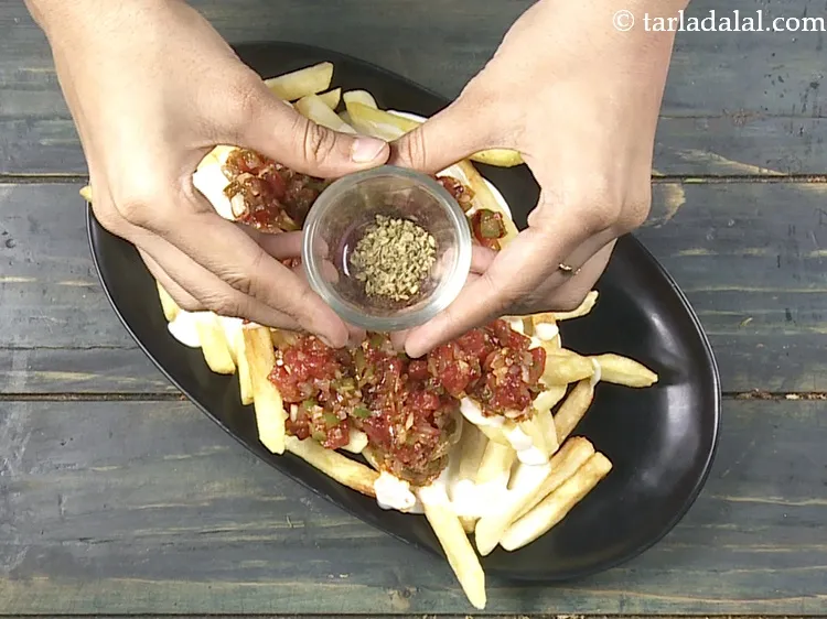 Step 30 – Finally top it with 1/4 tsp&nbsp;<a href="https://www.tarladalal.com/glossary-dried-oregano-268i">dried oregano</a>&nbsp;evenly over it.