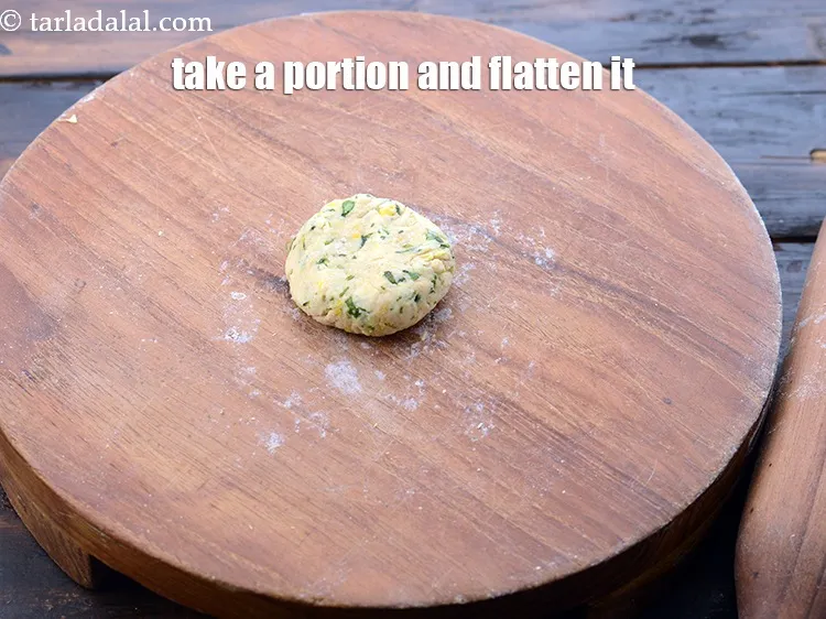 Step 22 – Take a portion and flatten it.&nbsp;