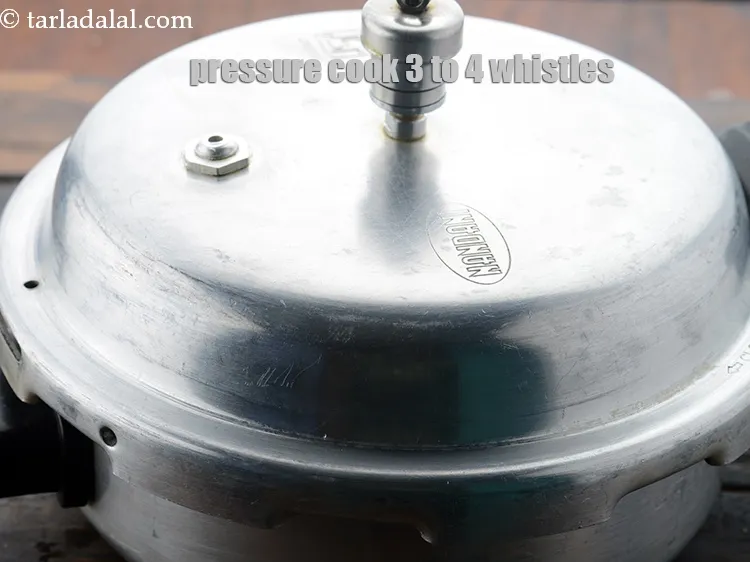 Step 12 – Close the lid and pressure cook it for 3 to 4 whistles.&nbsp;