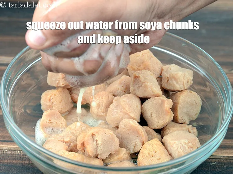 Step 6 – Squeeze out the water from the soya chunks and keep aside.