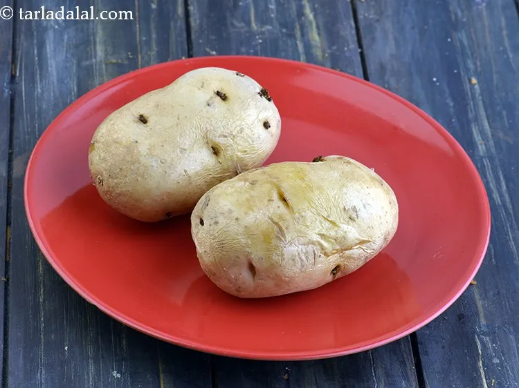 Step 9 – You can either pressure cook, <a href="https://www.tarladalal.com/How-To-Boil-Potatoes-in-A-Microwave-22482r" target="_blank">microwave</a> or boil them in a pot.