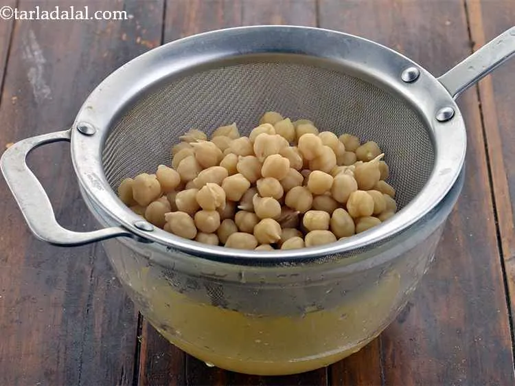 Step 7 – Drain the kabuli chana. Tip: Keep aside some cooking water of the chickpeas to add …