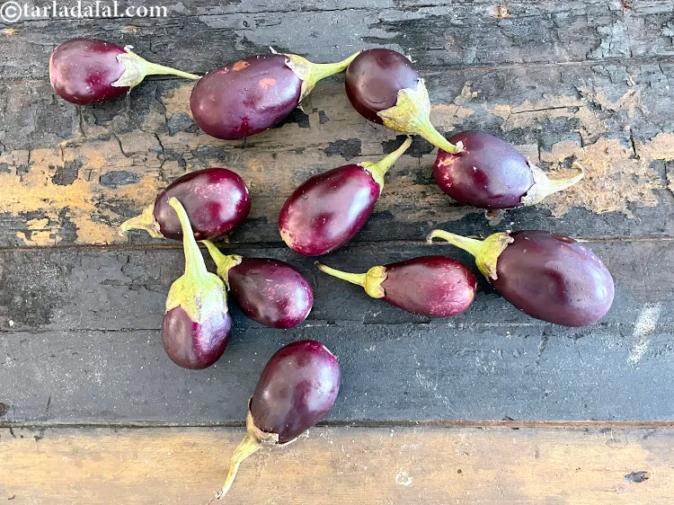 Step 3 – Choose the small variety of brinjals which are dark purple coloured for this sabzi.