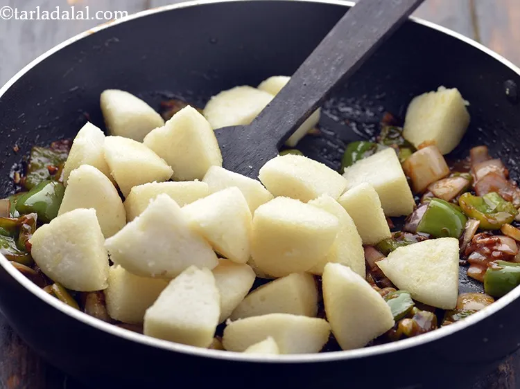Step 20 – Add the saut&eacute;ed idlis.