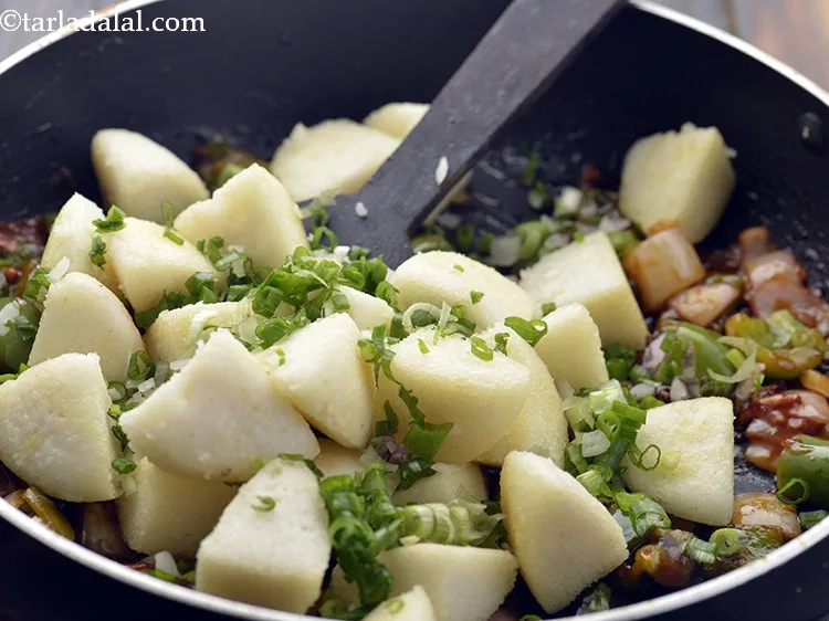Step 21 – Add the spring onions, mix gently so the sauces coat the&nbsp;<strong>Idli Chilli</strong>&nbsp;well. Do not cook …