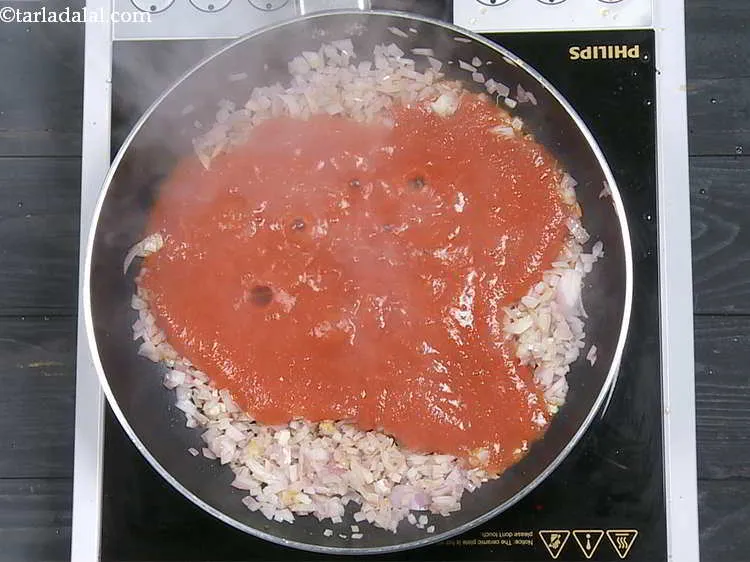 Step 9 – Add the tomato pulp. Refer our recipe with detailed step by step photos to make …