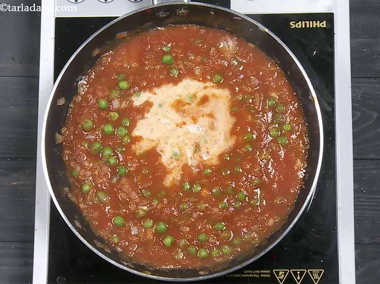 Step 16 – Add the milk. The addition of milk provides a rich texture to the idli curry.