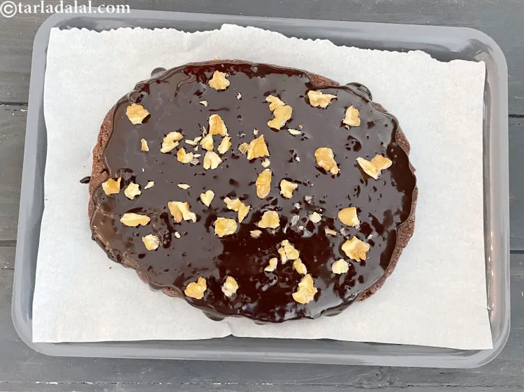 Step 23 – Top with 3 tablespoons&nbsp;<a href="glossary-chopped-walnuts-785i">chopped walnuts (akhrot)</a>.