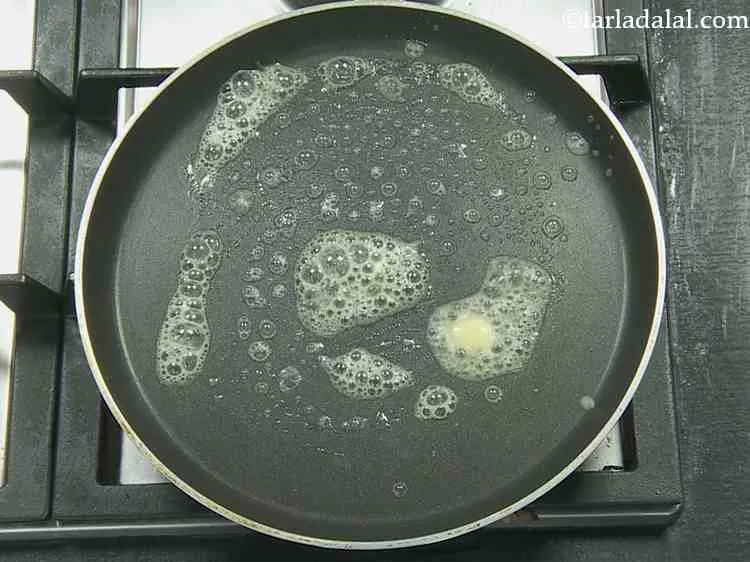 Step 14 – Heat a non-stick tava (griddle) and grease it with 1? tsp of butter.