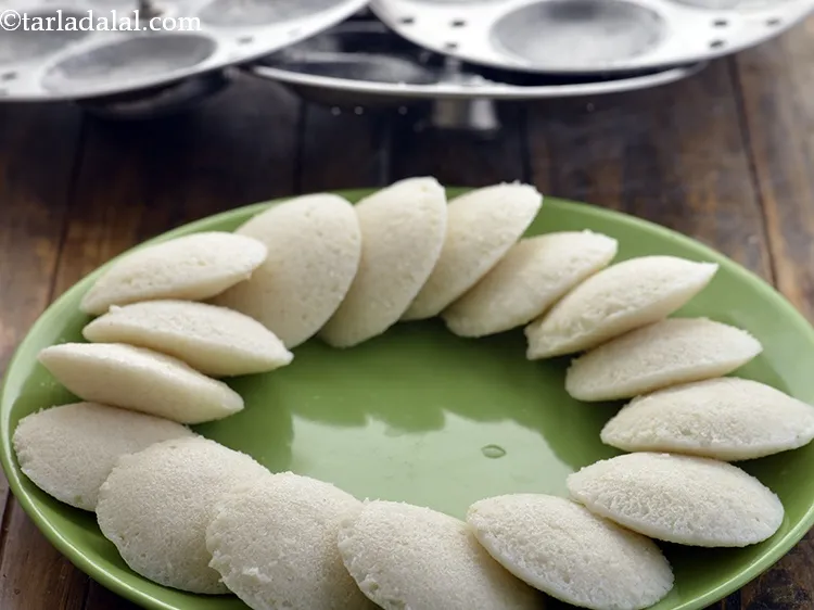 Step 28 – Allow the&nbsp;&nbsp;<strong>instant aval idli</strong>&nbsp;to cool a bit and then remove from molds using a spoon …