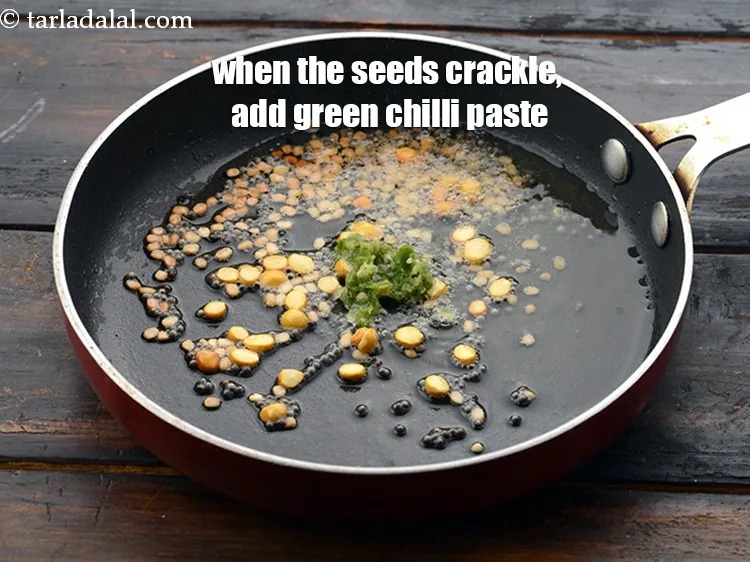 Step 21 – When the seeds crackle, add 1/4 tsp&nbsp;<a href="https://www.tarladalal.com/glossary-green-chilli-paste-hari-mirch-ki-paste-mirchi-paste-333i">green chilli paste</a>.&nbsp;