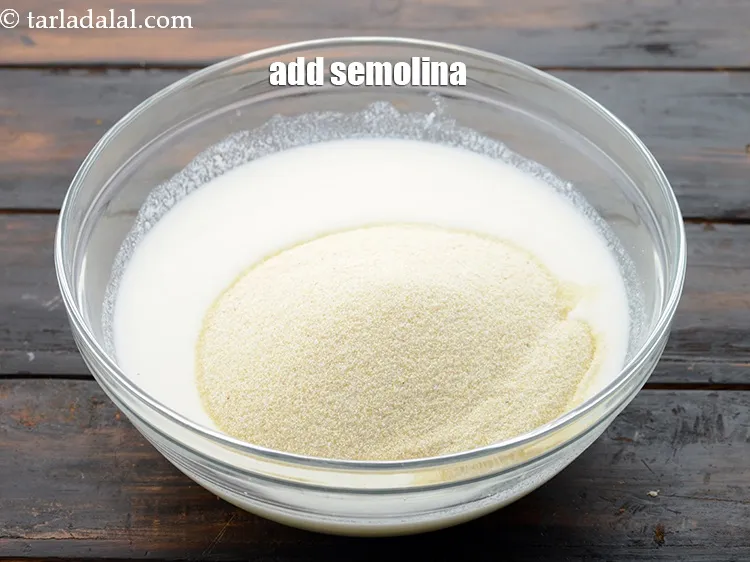 Step 7 – Add 1 1/4 cups&nbsp;<a href="https://www.tarladalal.com/glossary-semolina-sooji-rava-rawa-603i">semolina (rava / sooji)</a>.&nbsp;