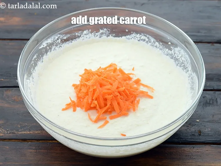 Step 12 – Add 2 tbsp&nbsp;<a href="https://www.tarladalal.com/glossary-grated-carrot-816i">grated carrot</a>.&nbsp;