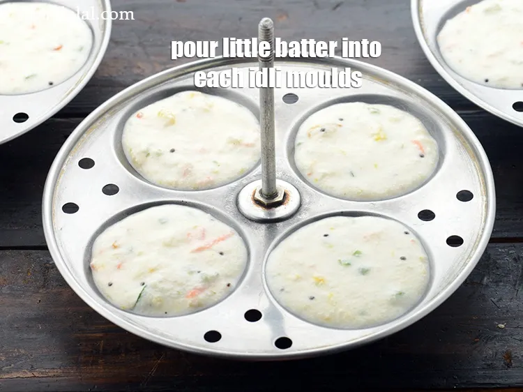 Step 31 – Pour spoonfuls of batter into each of the greased idli moulds. Do not over fill …