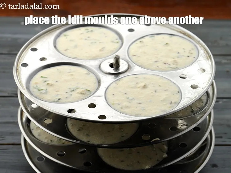 Step 32 – Once all your idli plates are filled and ready, place them one above another in …