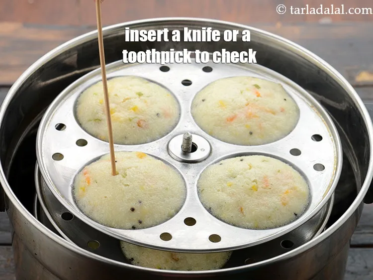 Step 34 – To check if the idli is cooked or no, insert a knife or a toothpick …